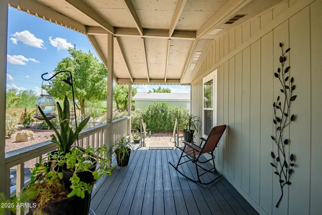 a view of a porch with furniture and wooden floor