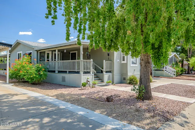 a front view of a house with a garden and plants