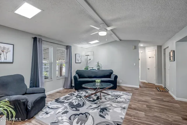 a living room with furniture and wooden floor