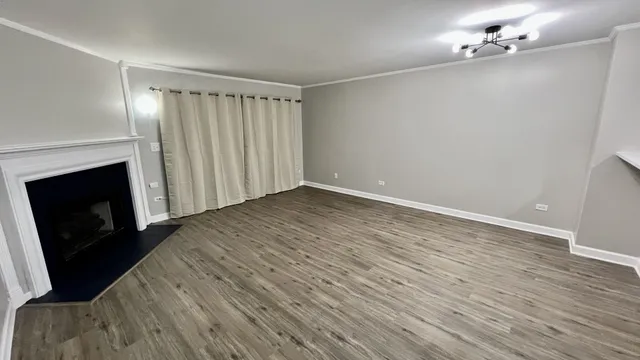 wooden floor in an empty room with a fireplace