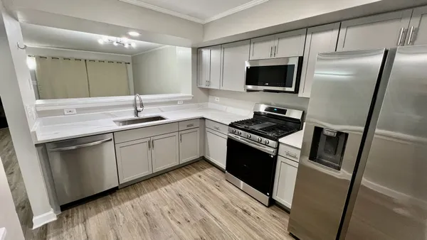a kitchen with a sink stainless steel appliances and cabinets