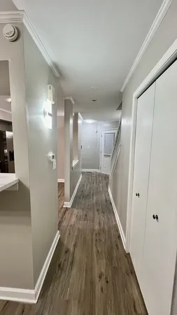 a view of a hallway with wooden floor
