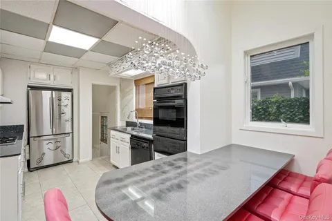 a kitchen with a refrigerator and a stove top oven