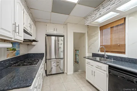 a kitchen with stainless steel appliances granite countertop a stove and a refrigerator