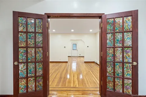 a view of spacious bedroom with a bed and wooden floor