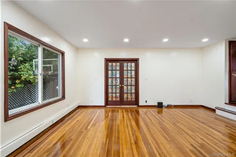a view of a room with wooden floor and iron stairs