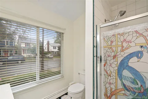 a bathroom with a toilet and a shower curtain