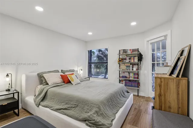 a bedroom with a large bed and a book shelf
