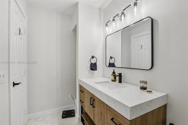 a bathroom with a sink vanity and a mirror