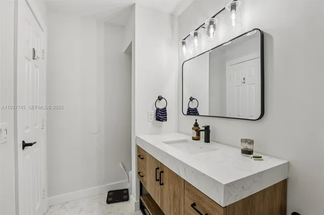 a bathroom with a sink vanity and a mirror
