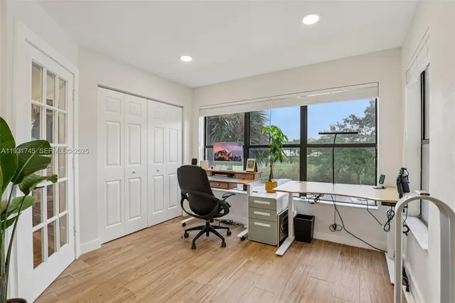 a view of a workspace with furniture and a window