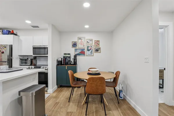 a view of a dining room with furniture and wooden floor
