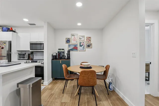 a view of a dining room with furniture and wooden floor