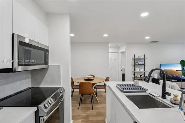 a kitchen that has a sink and a stove in it