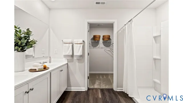 a storage room with wooden floor and cabinets