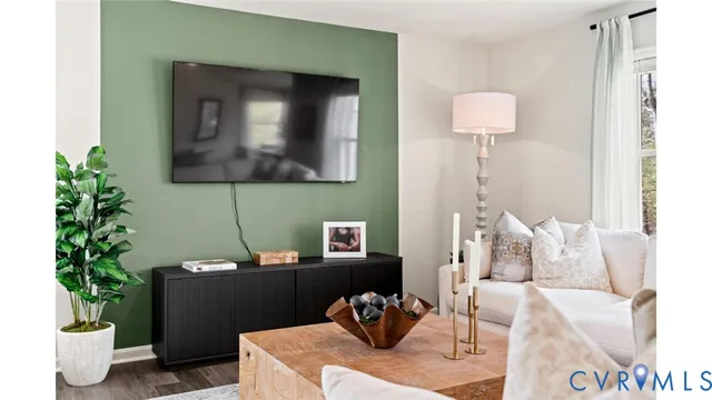 a living room with furniture and a potted plant