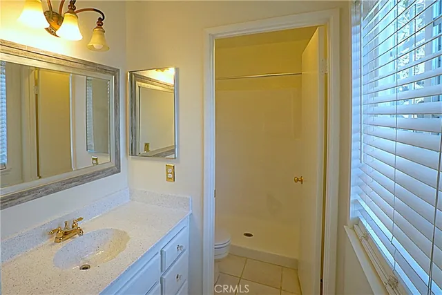 a bathroom with a tub a sink and a large mirror