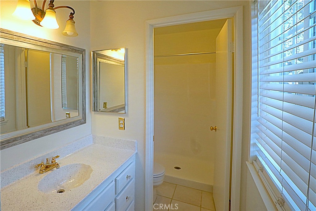 1152 Athena Court Riverside, CA 92507 - Photo 9 of 11 a bathroom with a tub a sink and a large mirror