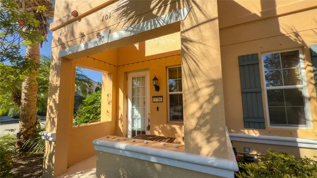 a view of a brick house with a large windows and a table and chairs