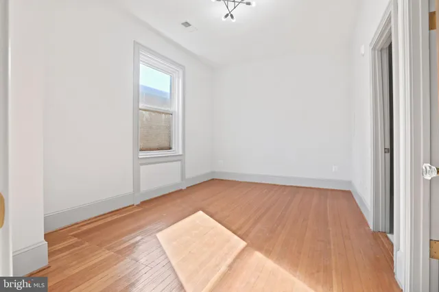 a view of an empty room and wooden floor