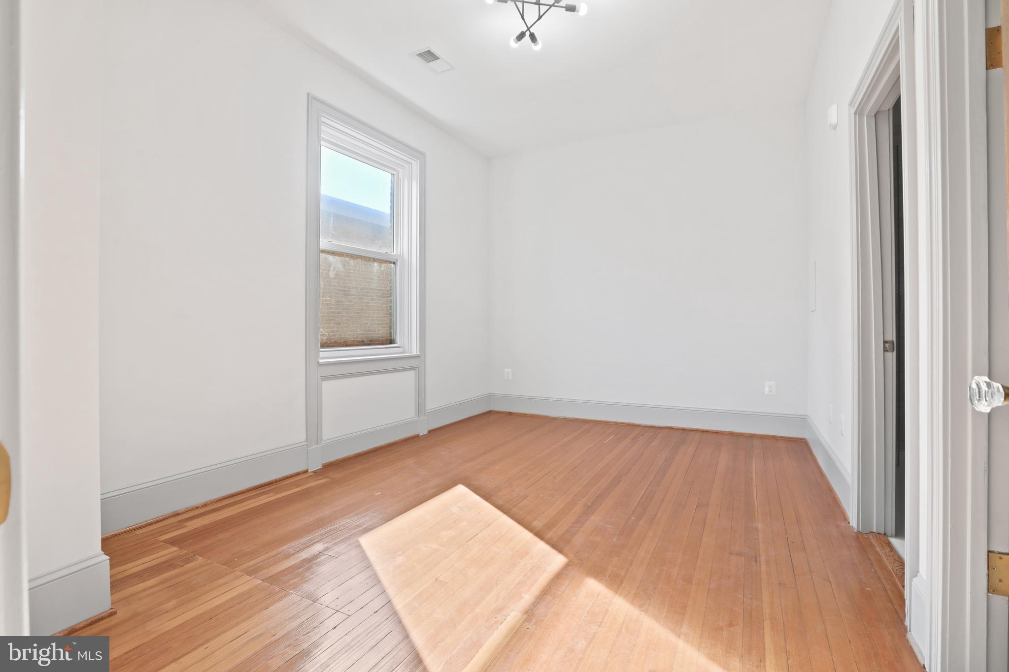 812 Park Avenue, Unit 3FF Baltimore, MD 21201 - Photo 11 of 17 a view of an empty room and wooden floor