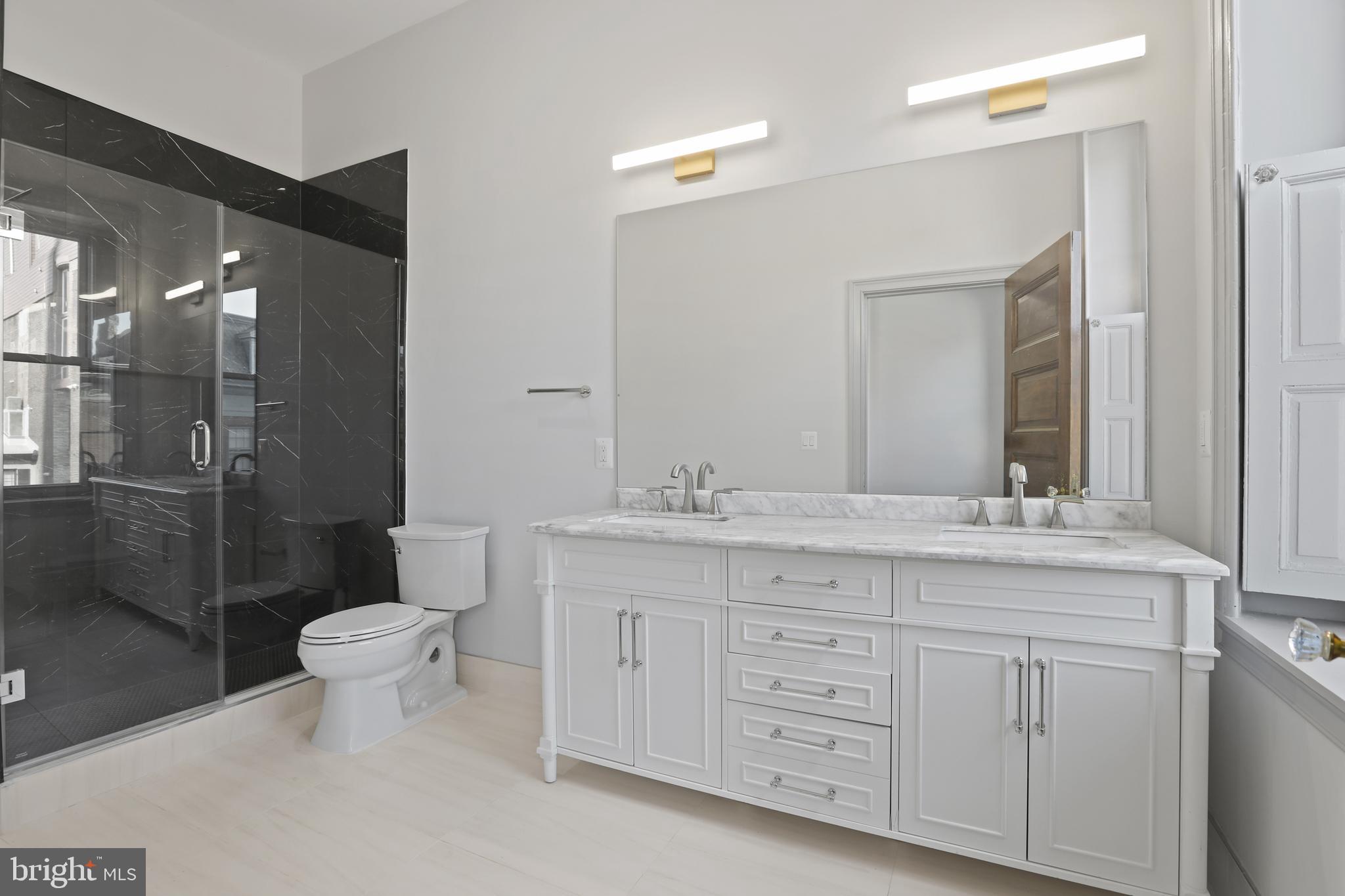 812 Park Avenue, Unit 3FF Baltimore, MD 21201 - Photo 14 of 17 a bathroom with a granite countertop sink toilet and shower