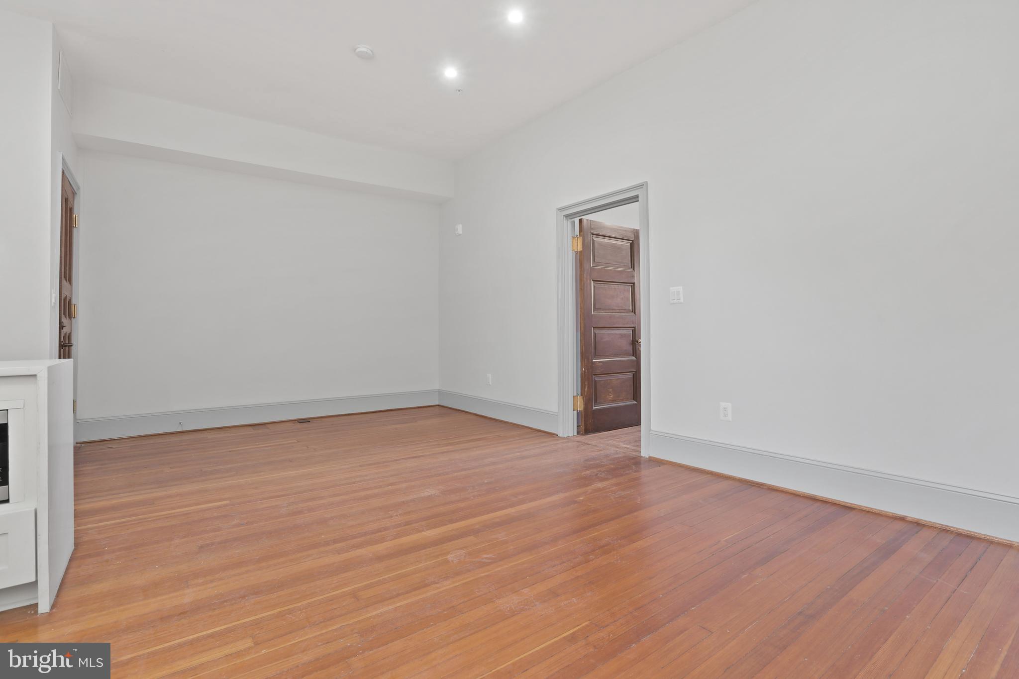 812 Park Avenue, Unit 3FF Baltimore, MD 21201 - Photo 16 of 17 a view of an empty room with wooden floor and a window