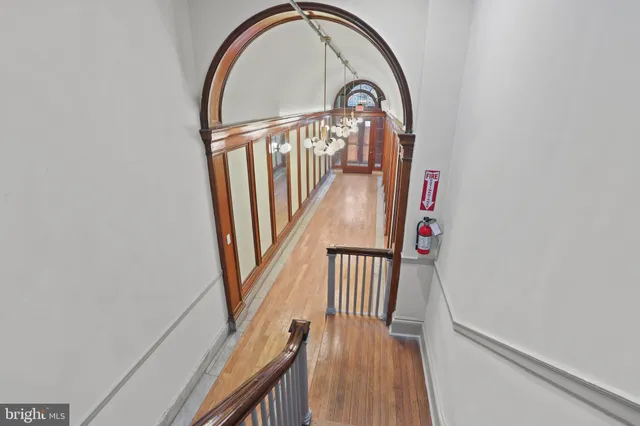 a view of staircase with railing and a window