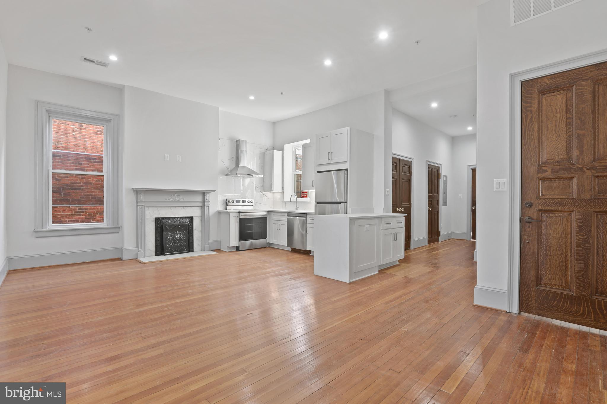 812 Park Avenue, Unit 3FF Baltimore, MD 21201 - Photo 7 of 17 a view of a kitchen with wooden floor and a kitchen