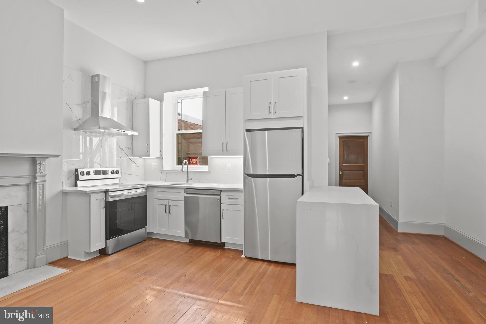 812 Park Avenue, Unit 3FF Baltimore, MD 21201 - Photo 8 of 17 a kitchen with a refrigerator sink and cabinets