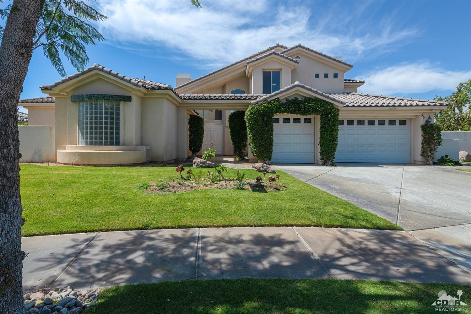 35 Sherwood Road Rancho Mirage, CA 92270 - Photo 1 of 25 a front view of a house with a yard and garage