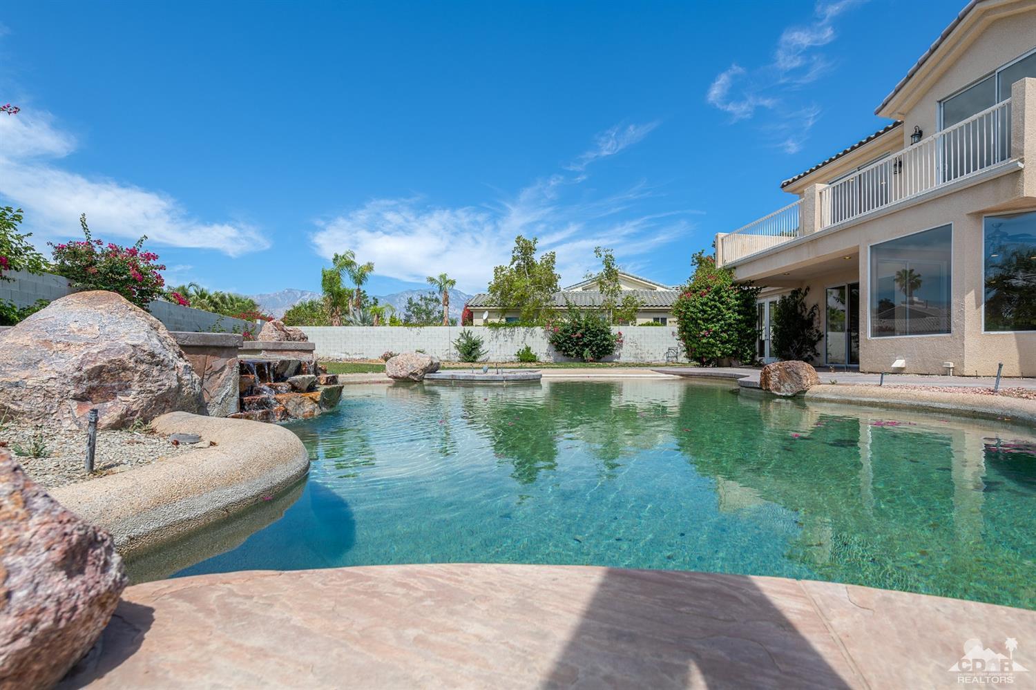35 Sherwood Road Rancho Mirage, CA 92270 - Photo 2 of 25 a swimming pool with outdoor seating and yard