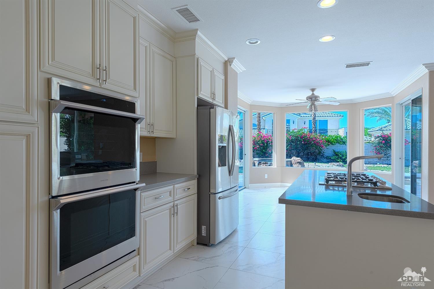 35 Sherwood Road Rancho Mirage, CA 92270 - Photo 13 of 25 a kitchen with stainless steel appliances granite countertop a refrigerator and a stove