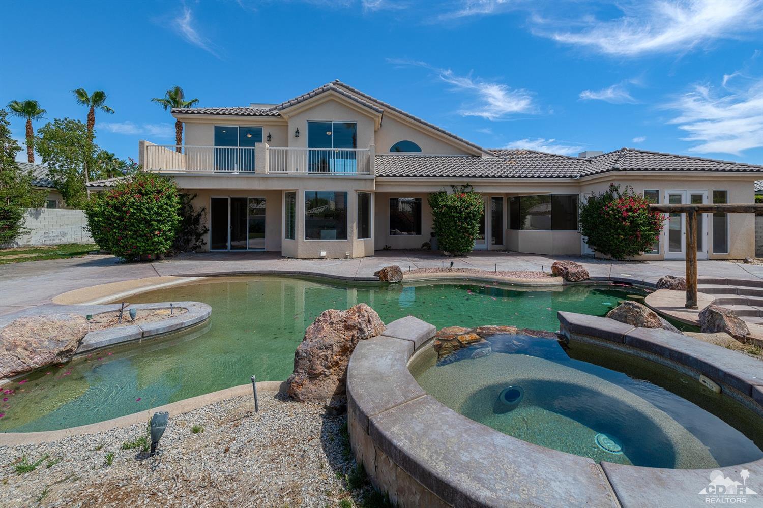 35 Sherwood Road Rancho Mirage, CA 92270 - Photo 16 of 25 a view of a house with swimming pool and a yard