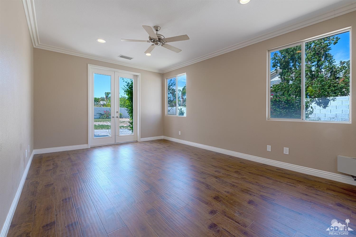35 Sherwood Road Rancho Mirage, CA 92270 - Photo 18 of 25 a view of an empty room with wooden floor and a window