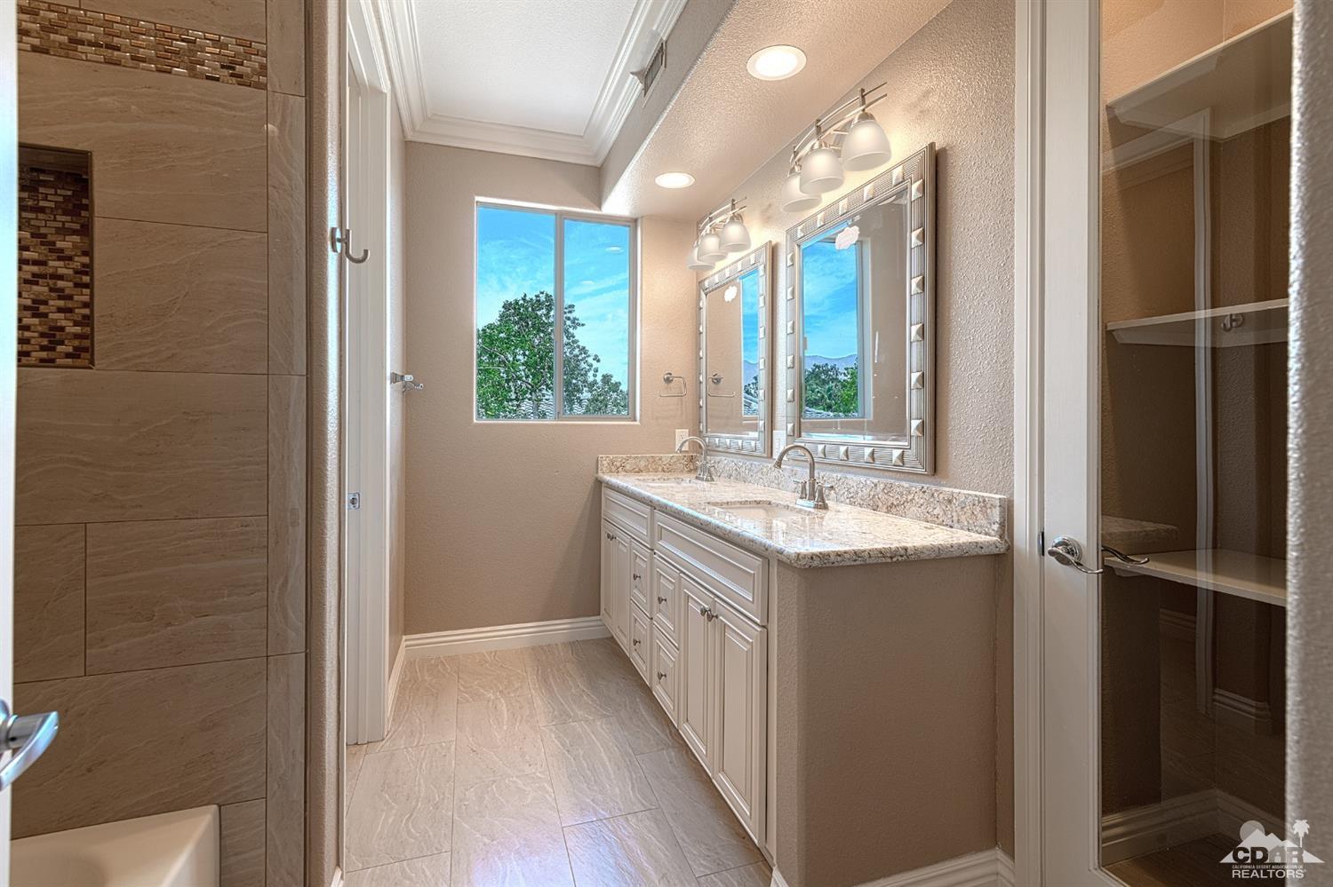 35 Sherwood Road Rancho Mirage, CA 92270 - Photo 20 of 25 a bathroom with a granite countertop sink and a mirror