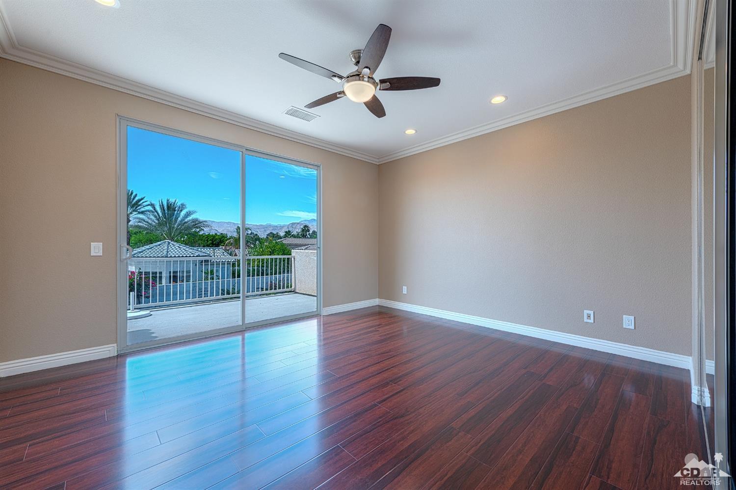 35 Sherwood Road Rancho Mirage, CA 92270 - Photo 21 of 25 a view of a livingroom with wooden floor and a ceiling fan