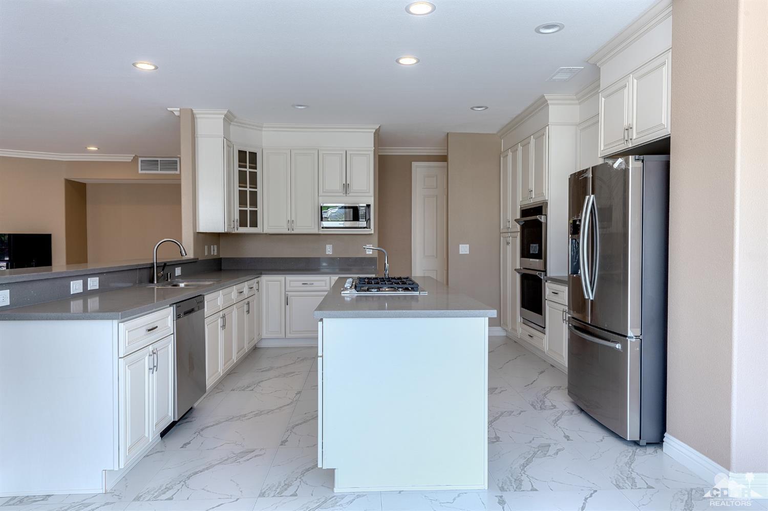 35 Sherwood Road Rancho Mirage, CA 92270 - Photo 10 of 25 a kitchen with stainless steel appliances a refrigerator sink and stove