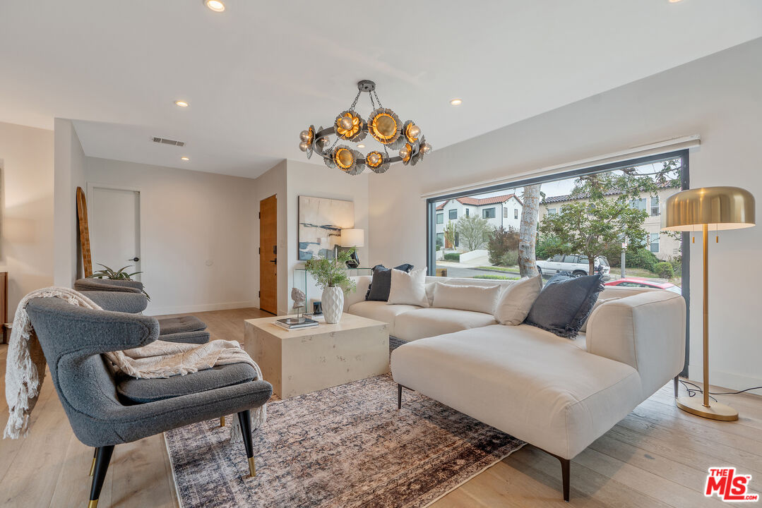 1645 South Sierra Bonita Avenue Los Angeles, CA 90019 - Photo 11 of 62 a living room with furniture and a large window