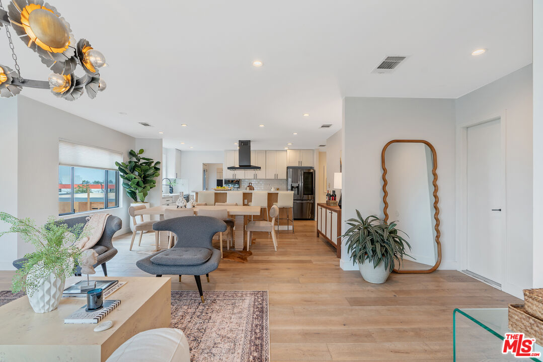 1645 South Sierra Bonita Avenue Los Angeles, CA 90019 - Photo 13 of 62 a living room with furniture potted plant and kitchen view
