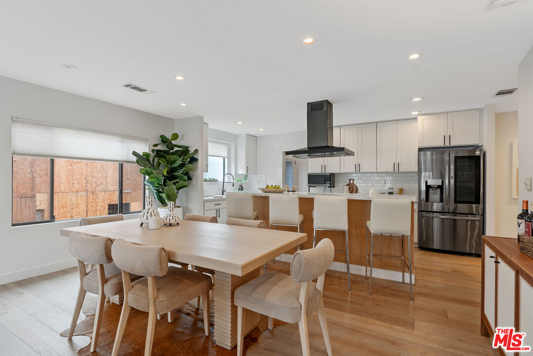 1645 South Sierra Bonita Avenue Los Angeles, CA 90019 - Photo 14 of 62 a view of kitchen with refrigerator dining table and chairs
