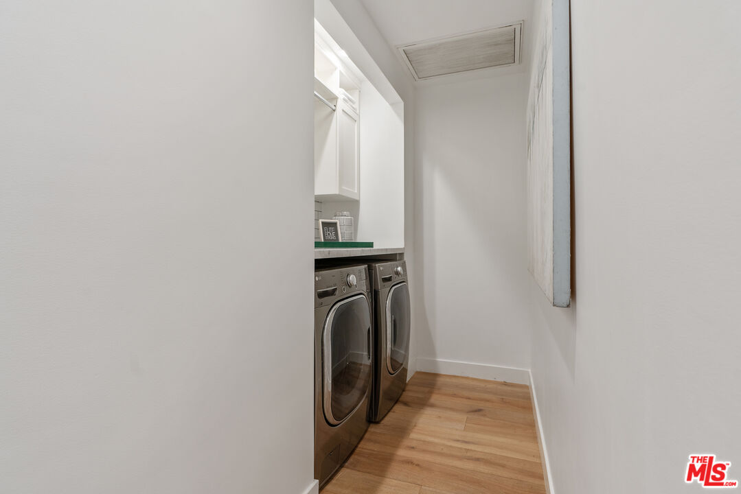1645 South Sierra Bonita Avenue Los Angeles, CA 90019 - Photo 24 of 62 a view of a hallway with a washer and dryer