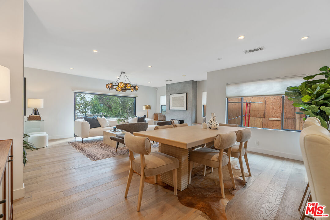 1645 South Sierra Bonita Avenue Los Angeles, CA 90019 - Photo 25 of 62 a view of a dining room with furniture window and wooden floor