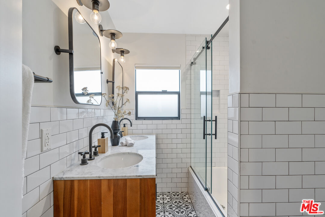 1645 South Sierra Bonita Avenue Los Angeles, CA 90019 - Photo 26 of 62 a bathroom with a sink a toilet and shower