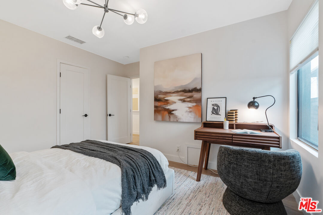 1645 South Sierra Bonita Avenue Los Angeles, CA 90019 - Photo 30 of 62 a bedroom with furniture and wooden floor