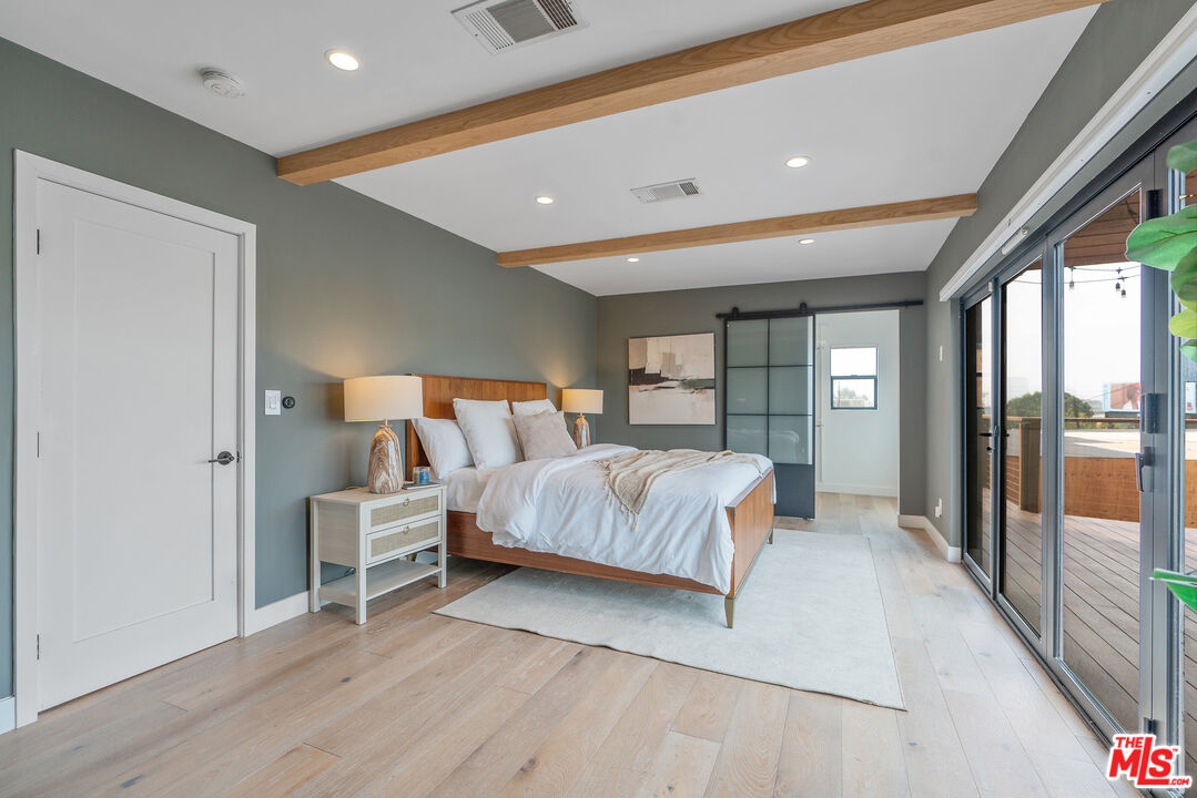 1645 South Sierra Bonita Avenue Los Angeles, CA 90019 - Photo 32 of 62 a bedroom with a large bed and a large window