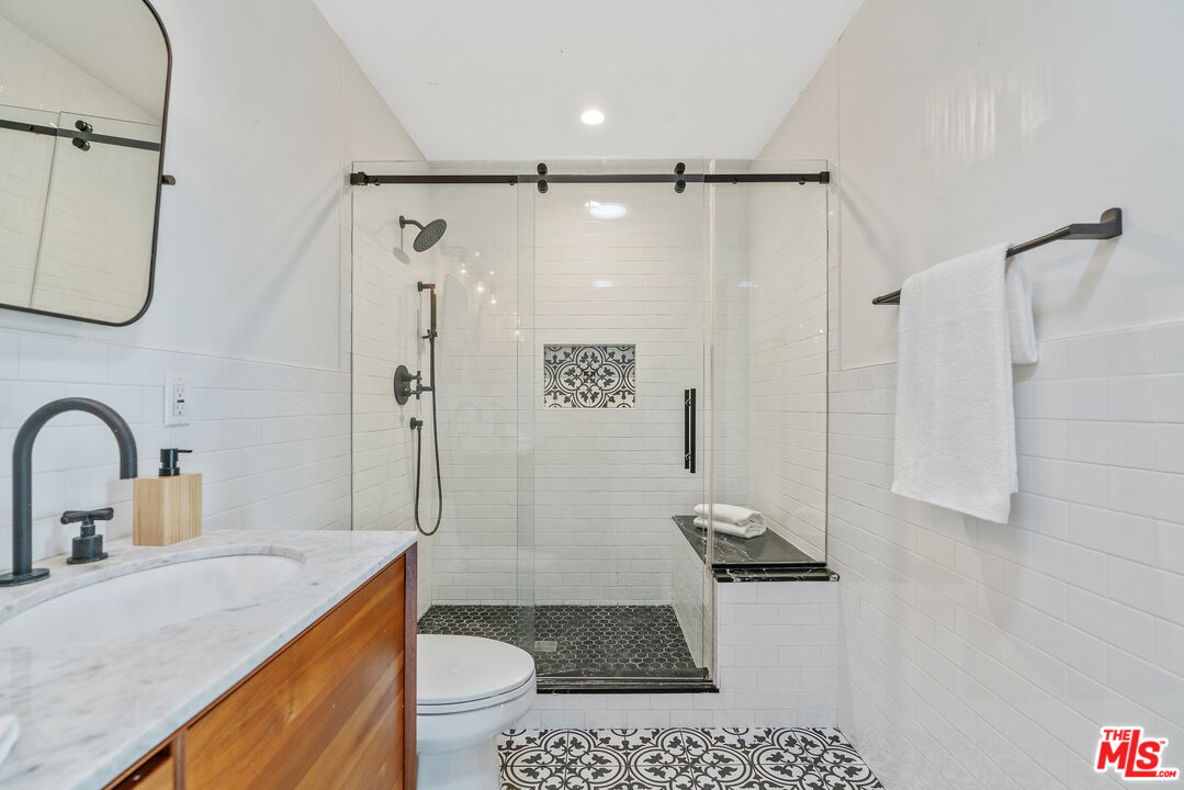 1645 South Sierra Bonita Avenue Los Angeles, CA 90019 - Photo 38 of 62 a bathroom with a sink a toilet and a shower