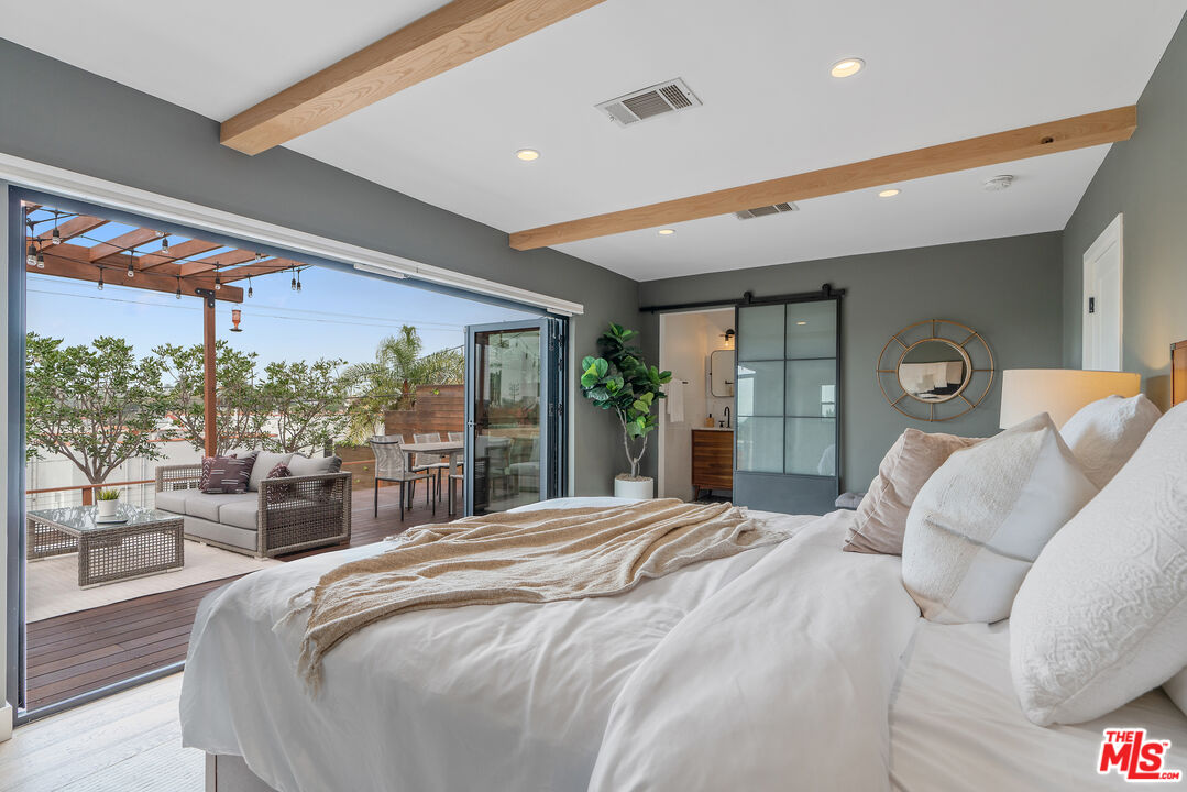 1645 South Sierra Bonita Avenue Los Angeles, CA 90019 - Photo 39 of 62 a bed sitting in a bedroom next to a large window