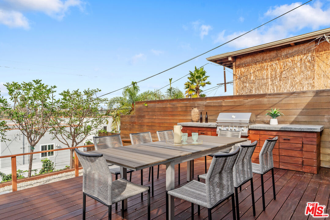 1645 South Sierra Bonita Avenue Los Angeles, CA 90019 - Photo 46 of 62 a outdoor dining space with furniture and wooden floor