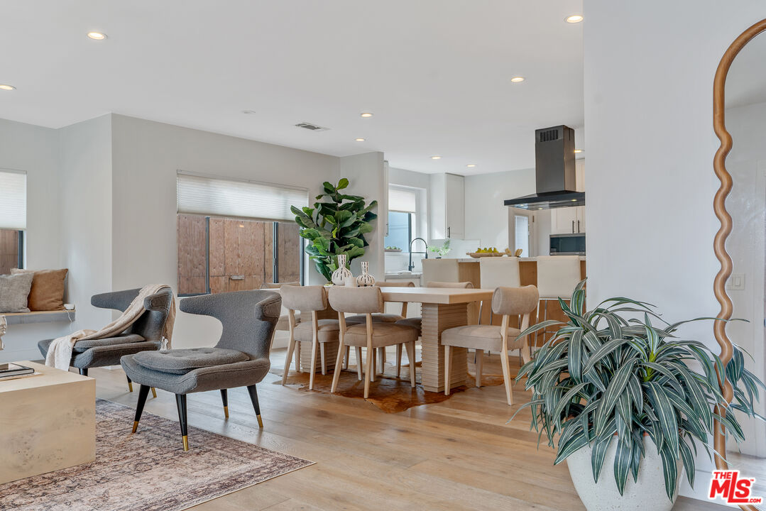 1645 South Sierra Bonita Avenue Los Angeles, CA 90019 - Photo 6 of 62 a living room with lots of furniture and a potted plant